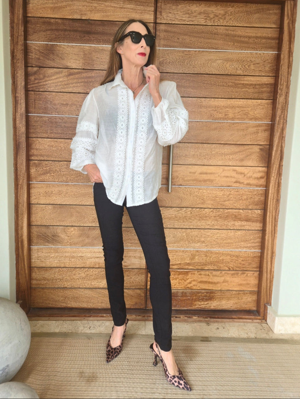 White blouse with lace detail and elasticated cuff.