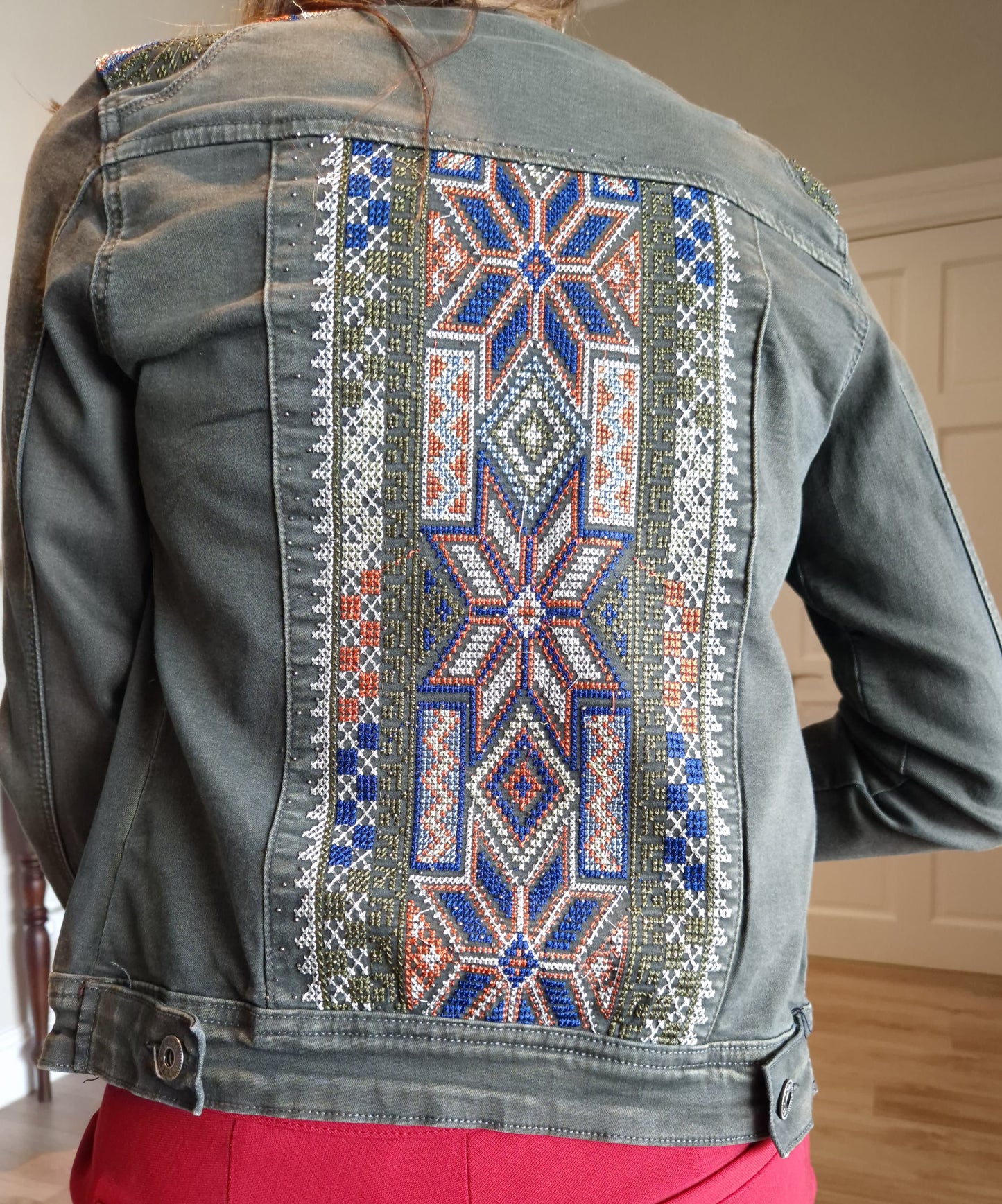 Denim jacket with embroidered detail on shoulder and back