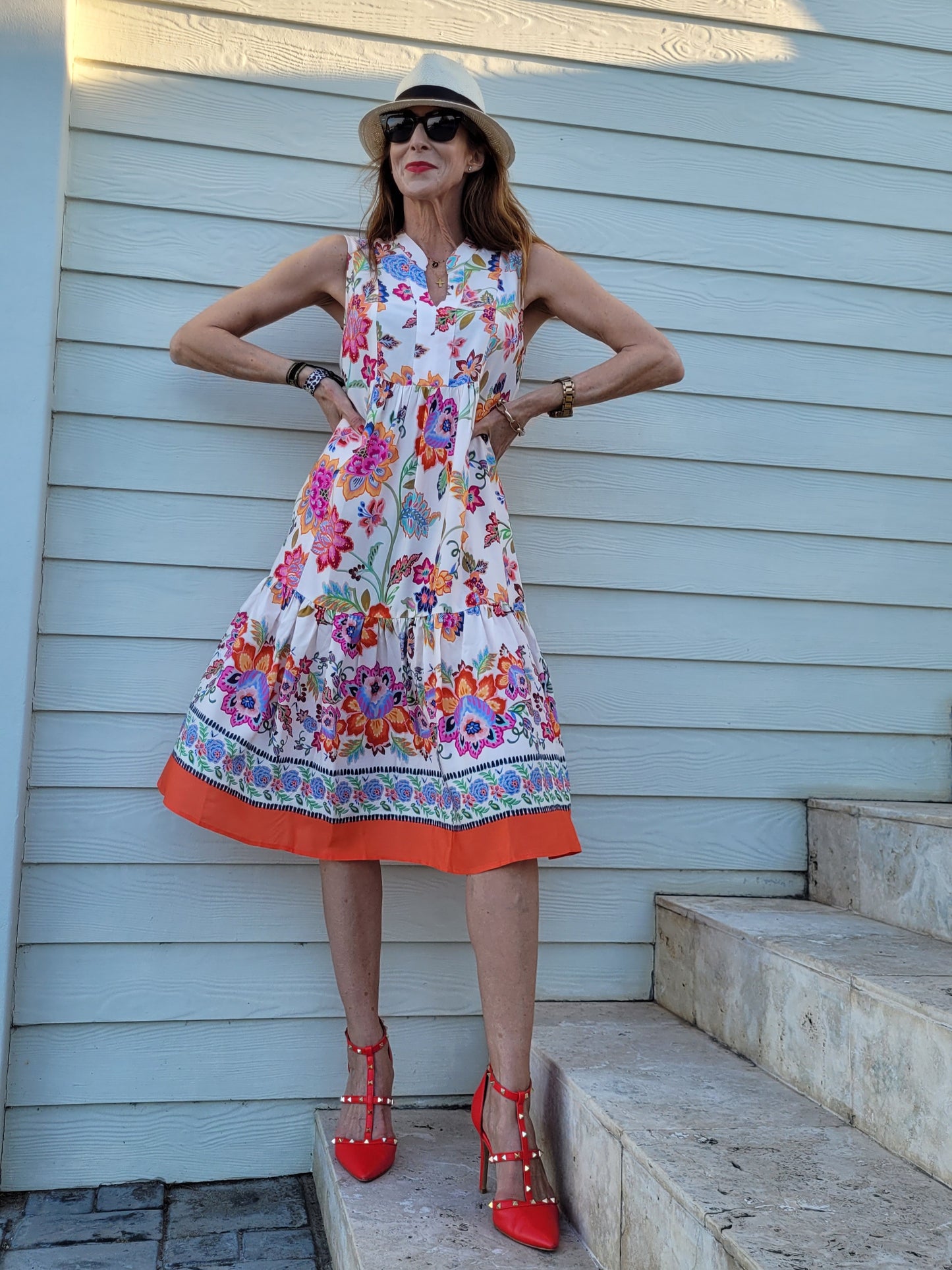 Fleur sleeveless dress with frill hem and pockets.