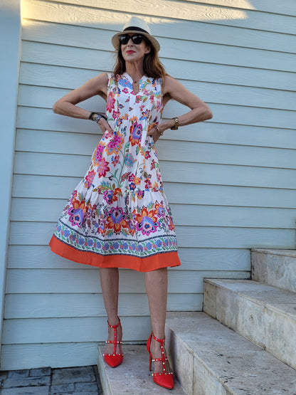 Fleur sleeveless dress with frill hem and pockets.