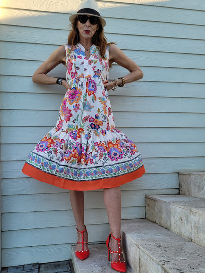 Fleur sleeveless dress with frill hem and pockets.