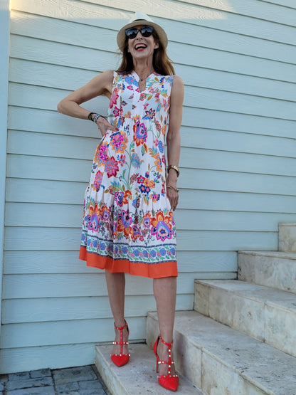 Fleur sleeveless dress with frill hem and pockets.