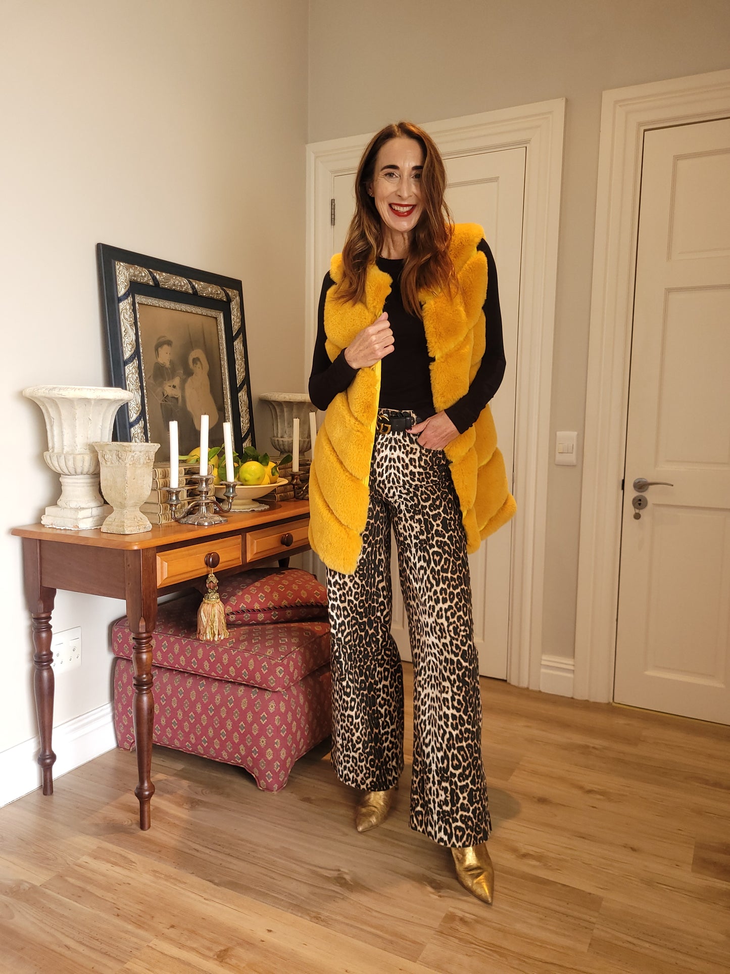 Sleeveless longer length mustard yellow faux fur jacket with side pockets.