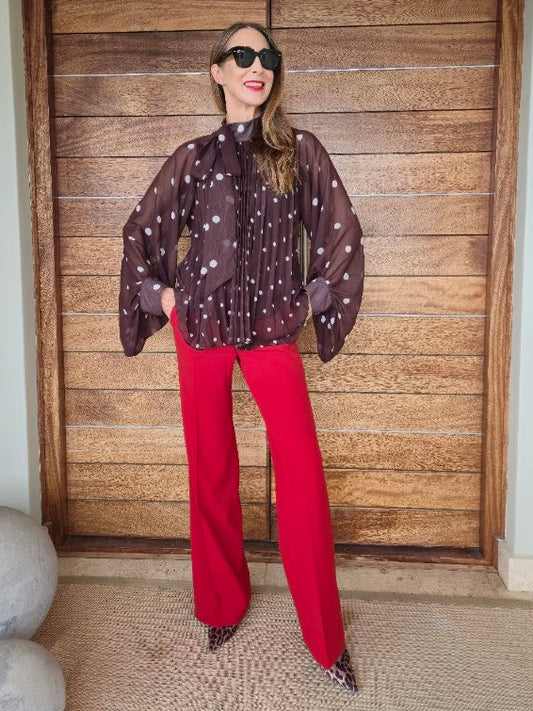 Sheer oversize fit polkadot blouse with pleated detail.