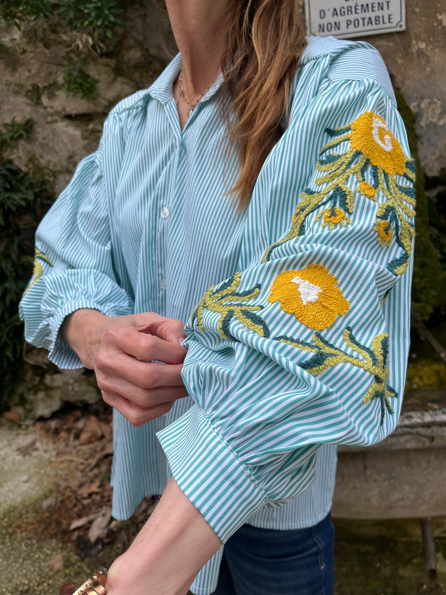 Button down oversize green/white striped shirt with embroidered sleeves.