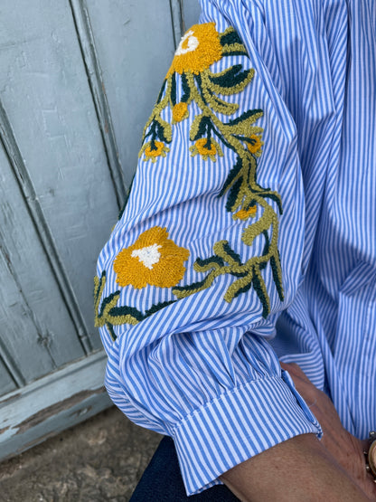 Button down oversize blue/white striped shirt with embroidered sleeves.