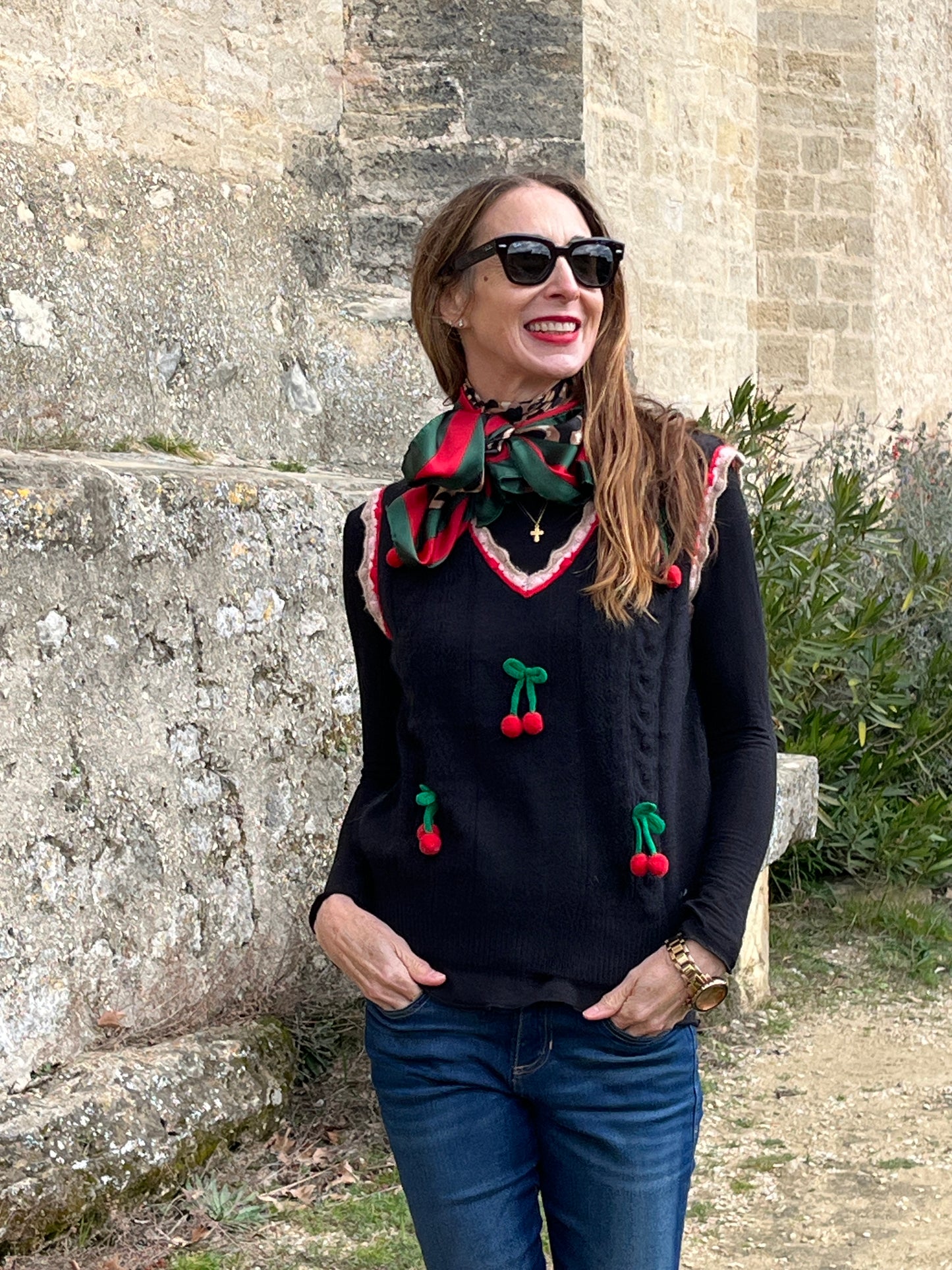 Knitted black waistcoat with cherry detail.