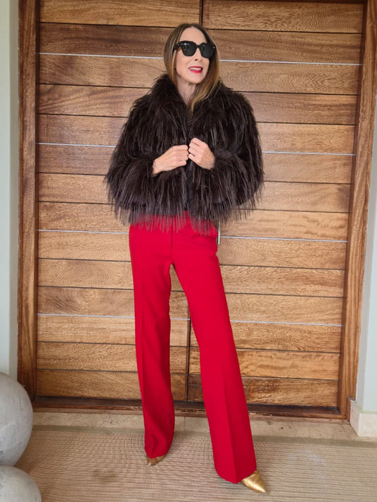 Fully lined chocolate faux fur with side pockets and metal closures on the front.