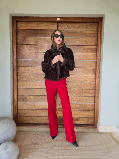 Chocolate faux fur with side pockets and metal closures on the front.