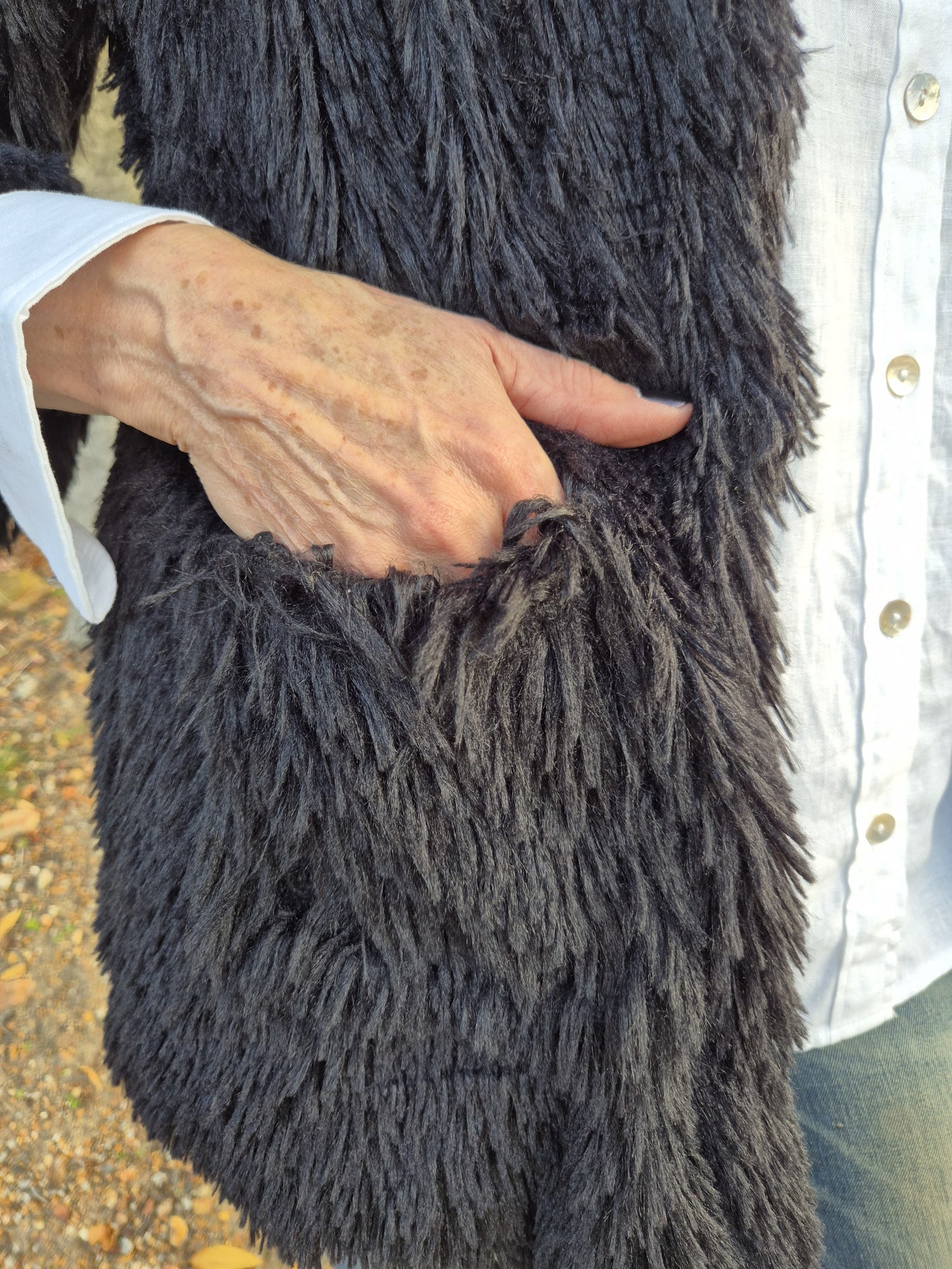 Shaggy black faux fur with pockets.