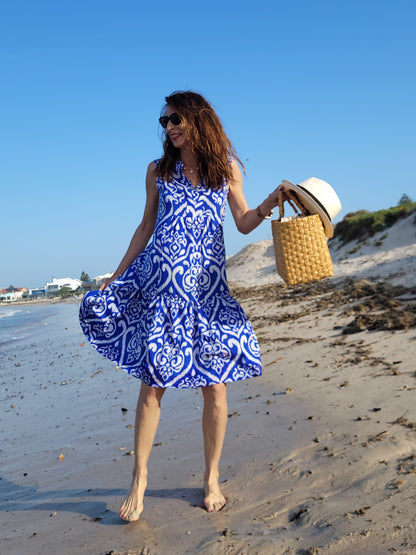 Fleur sleeveless dress with frill hem and pockets.